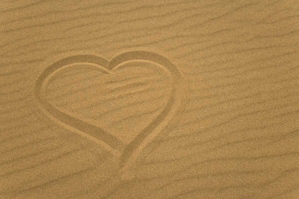 Heart outline drawn in sand